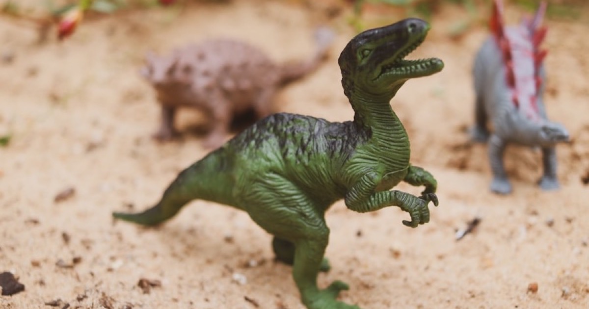 Toy dinosaurs in the sand